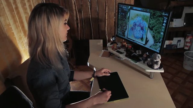 girl designer draws on graphic tablet
