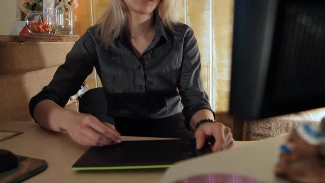 girl designer draws on graphic tablet