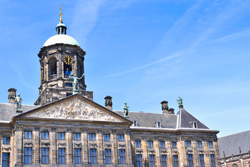 Fototapeta na wymiar City hall or town hall of Amsterdam, the Netherlands. Historic building facade with bell tower and blue sky.