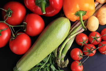 Fototapeta na wymiar Fresh, raw, organic vegetables on black background. Cooking, Healthy eating concept.