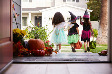 Fototapeta premium Three Children In Halloween Costumes Trick Or Treating