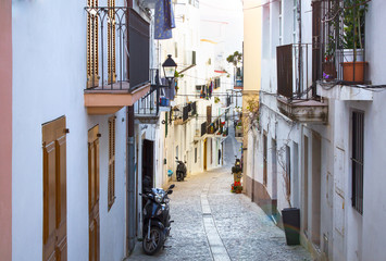 Path through the old Spanish town between the beautiful buildings