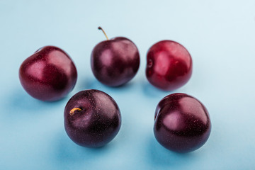 plums  on a blue  background