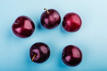 plums  on a blue  background