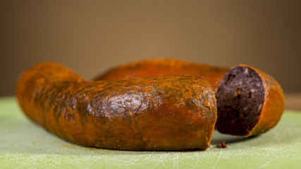 Traditional homemade blood sausage, covered by red lard