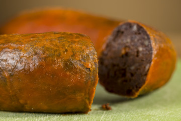 Close-up of traditional homemade blood sausage, covered by red lard