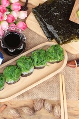 Fototapeta na wymiar Sushi roll and seaweed salad is delicious.