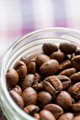 Coffee beans in glass containers. Macro.