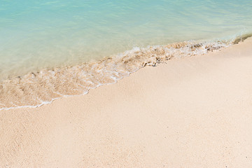 Fototapeta na wymiar Close up of white tropical Caribbean beach with shallow water.