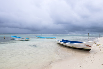boats on a beautiful tropical beach in a rainy day