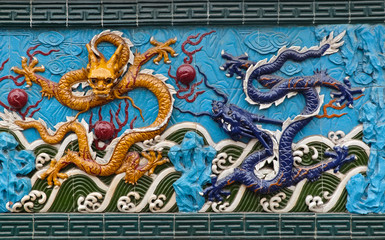 Traditional detail of a chinese ceramic dragons on the wall.