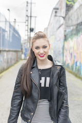 Fototapeta premium Urban portrait of smiling woman in the street.