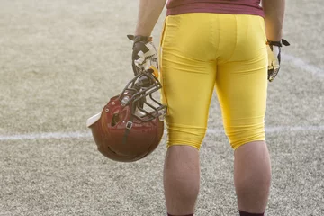 Tuinposter American football sportsman player holding helmet © zphoto83