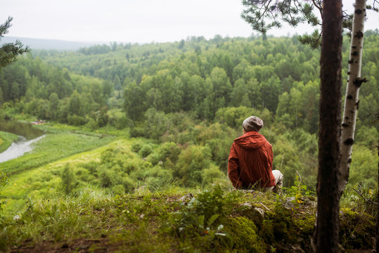 Caucasian man admiring scenic view from rural hilltop