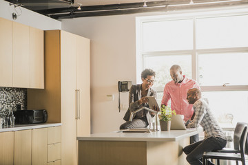 Business people talking in office kitchen