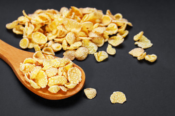 the glazed flakes in a glass dish are isolated on a black backgr
