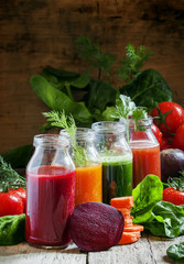 Four kind of vegetable juices: red, burgundy, orange, green, in