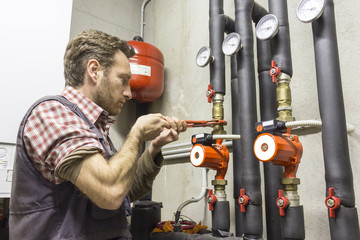 plumber at work installing a circulation pump