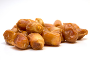 Date fruite isolated on a white background with a shallow focus