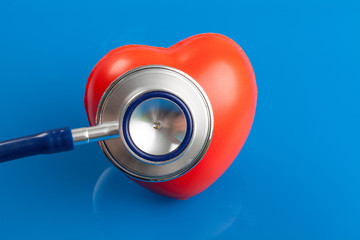 Stethoscope and heart on a blue background