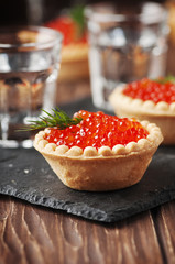 Traditional russian red caviare on the wooden table