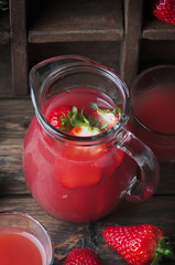 Sweet delicious strawberry juice on the wooden table