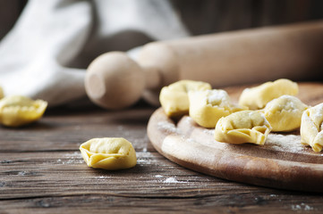 Italian traditional tortellini on the wooden table