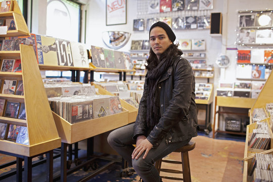 Portrait of a young man in a record store