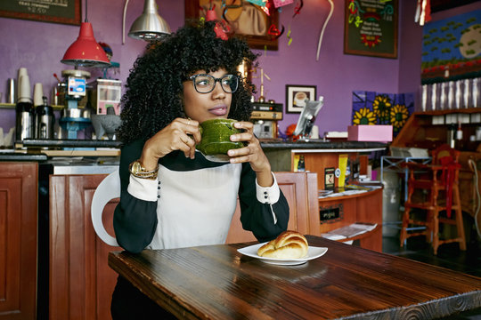 Woman Drinking Coffee In Cafe