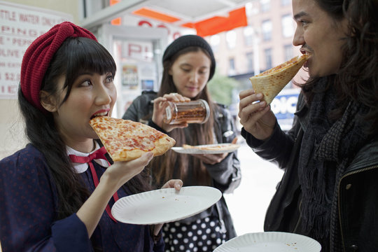 Friends hanging out eating pizza