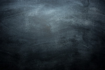 Obraz na płótnie Canvas Dirty blackboard with chalk traces, black background