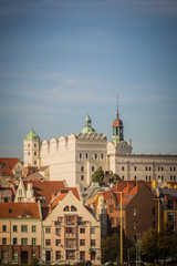 Fototapeta na wymiar Ducal Castle, Szczecin (Poland) in the sunny day with residential buildings in old town