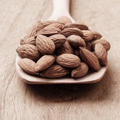 Almonds on wooden spoon