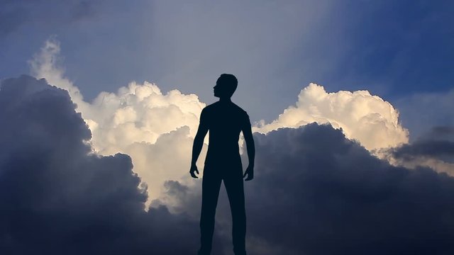 The man stand against the background of volume cloud. Time lapse. Wide angle