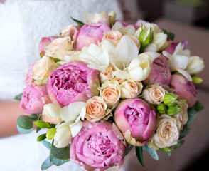 Colorful bouquet of the bride with freesia and peonies, decoration for wedding