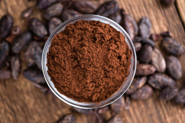 Cocoa powder on wooden background