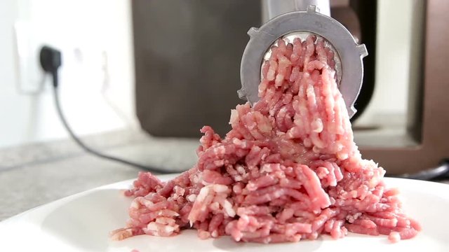 Forcemeat preparation in an electric meat grinder.