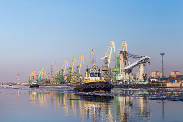 Cargo crane and tugboats in port, Saint Peterburg, Russia