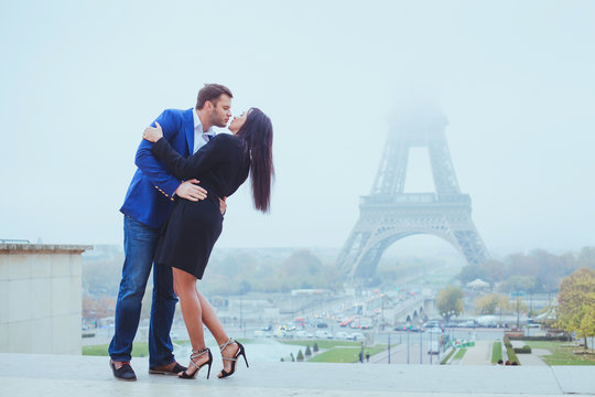 couple kissing near Eiffel Tower in Paris, valentines day destination in Europe, city of love
