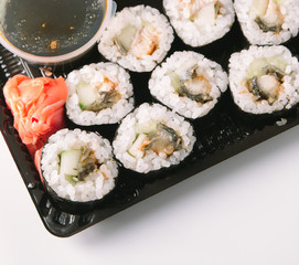 Open Sushi delivery box on white background. Top view.