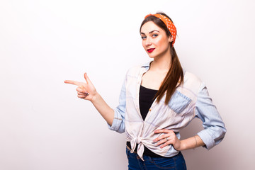 Young woman pointing  with forefinger, isolated on white background