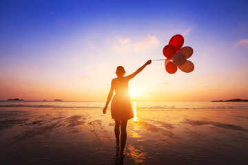 happiness concept, positive emotions, happy girl with multicolored balloons enjoying summer beach...