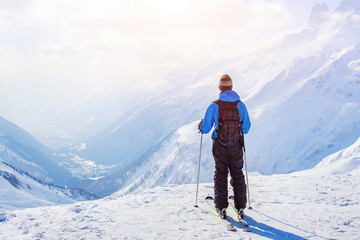 Fototapeta na wymiar skiing in Alps, skier on beautiful mountain background at sunset