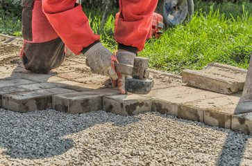 Worker paving a walkway