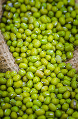 Beans in sack, on wood background