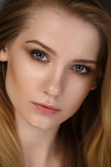 Obraz premium Close-up portrait of beautiful blond girl. Beauty woman. make-up. Smoky eyes. Gray background