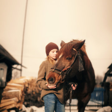 Girl holding rein of a horse