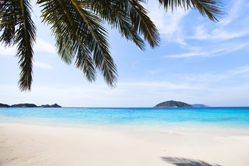 paradise beach background with copyspace, turquoise water, white sand and blue sky