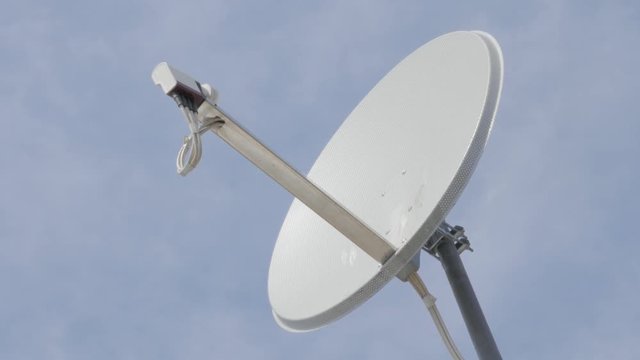High gain parabolic type satellite dish antena against blue sky 4k 3840X2160 UltraHD footage - Satellite antenna system slow pan 4K 2160p UHD video 