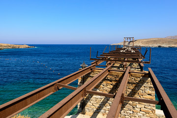 Old gantry projecting out to sea at Loutra port in Kythnos, Greece